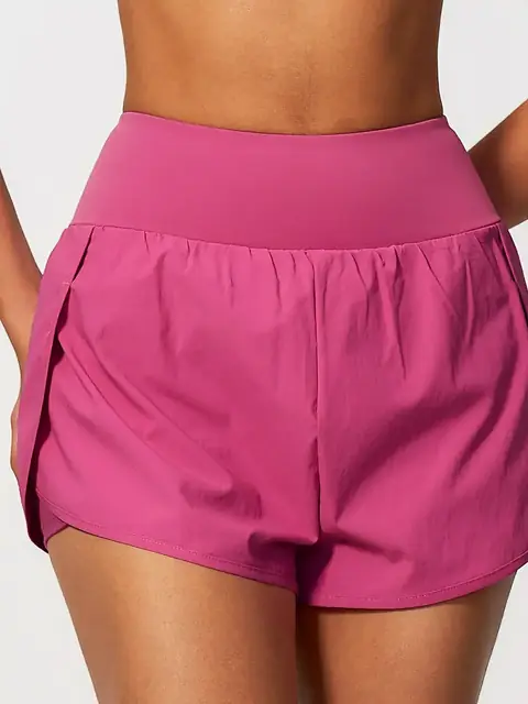 2-in-1 pocket run yoga shorts in sakura pink front view